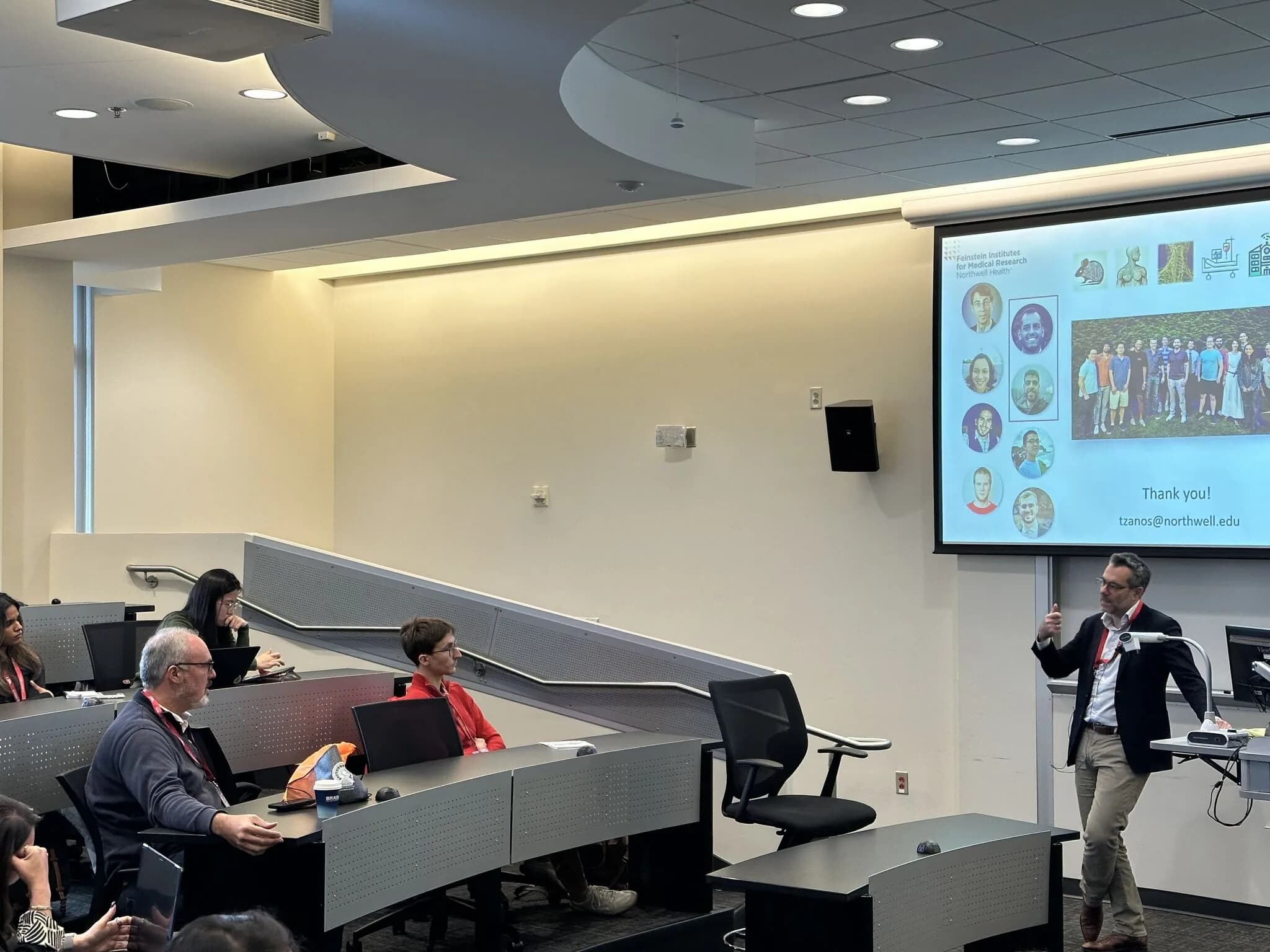 Theodoros Zanos presenting the Division of Health AI to a small auditorium